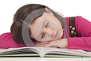 Little girl sleeping on a open book