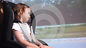 little girl sleeping in a safe baby car seat, girl fell asleep on time travel