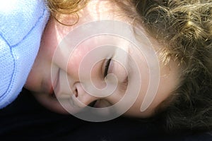 Little girl sleeping in the sun