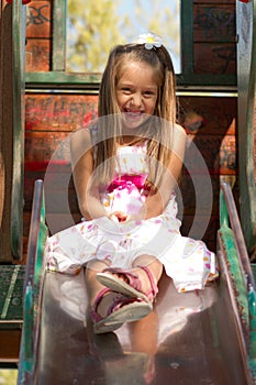 Little girl on a slide in the park