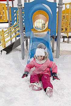 Little girl sliding on the slide