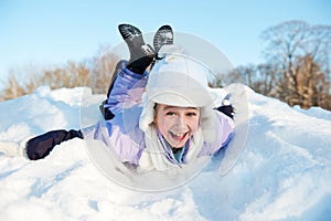 Little girl sliding in the snow