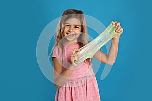 Little girl with slime on blue