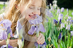 Little girl smelling flower