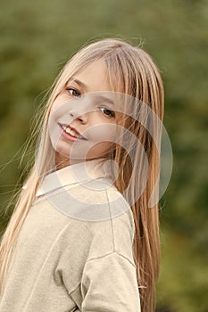 Little girl smile with long blond hair. Child with cute face outdoor. Beauty kid with fresh look and skin. Beauty look