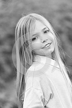 Little girl smile with long blond hair. Child with cute face outdoor. Beauty kid with fresh look and skin. Beauty look