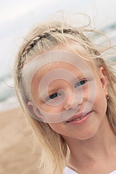 Little girl smiling at the beach in summer