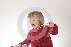 Little girl smiling happy. cute caucasian baby with bear and doll isolated on white background