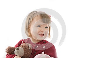 Little girl smiling happy. cute caucasian baby with bear and doll  on white background