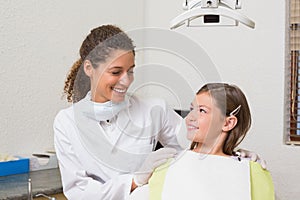 Little girl smiling with her pediatric dentist photo