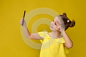 little girl smiling and making selfie on smartphone
