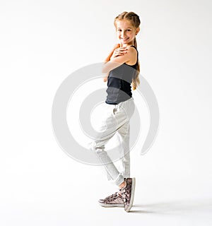 Little girl smiling standing in front of camera