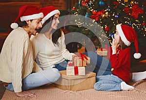 Little girl in Snata hat exclaiming happiness