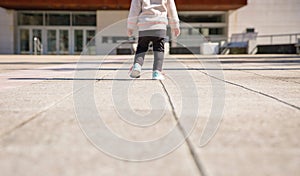 Little girl with sneakers and leggins training