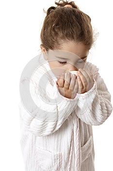Little girl sniffing fragrant soap