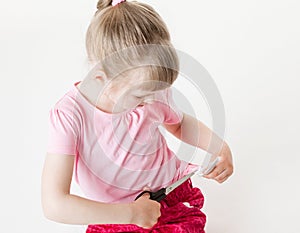 Little girl snipping off a brand label