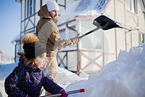 Little girl with a snow shovel.