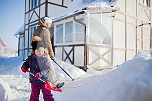 Little girl with a snow shovel.