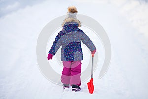 Little girl with a snow shovel.