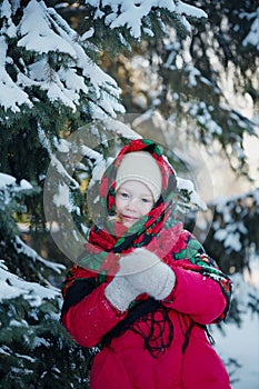 Little girl in the snowy woods. Winter day