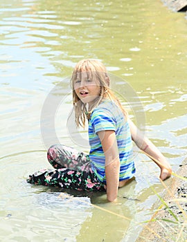 Little girl soaking wet in water