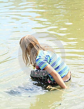 Little girl soaking wet in water