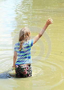 Little girl soaking wet in water