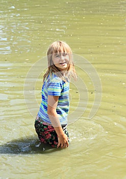 Little girl soaking wet in water