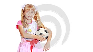 Little girl with a soccer ball.The concept of children`s sports.