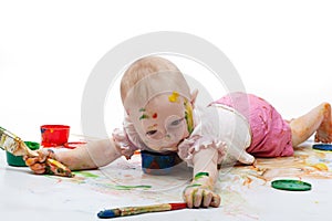 Little girl soiled by bright paints