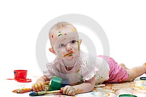 Little girl soiled by multi-colored paints