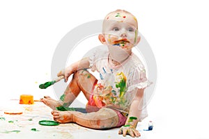 Little girl soiled by multi-colored paints