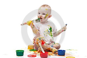 Little girl soiled by multi-colored paints