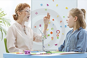 Little girl during speech therapy photo