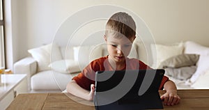 Little girl spend time on internet using digital tablet