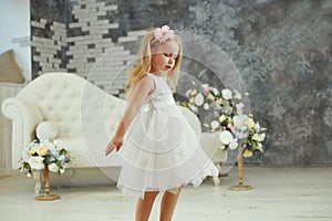 Little girl are spining in white luxury dress photo