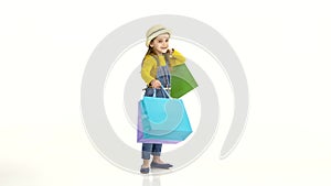 Little girl spinning around itself with colorful packages. White background