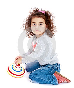 Little girl spinning a dreidel