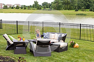 Little girl standing amongst garden furniture