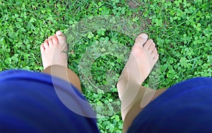 Little girl standing barefeet in the grass photo