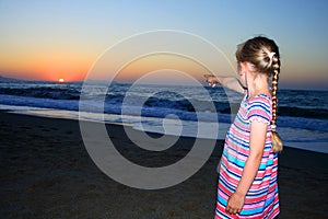 Little girl standing on the beach