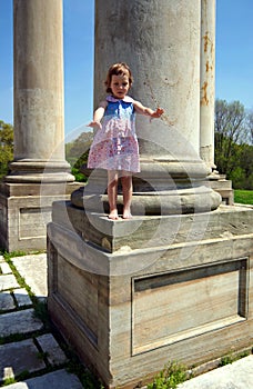 Little girl standing on the column