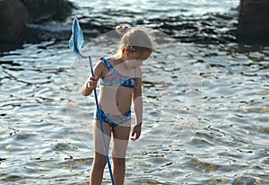 Little girl standing with fishing net