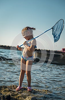 Little girl standing with fishing net