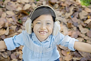 Little girl standing in the park at autumn season