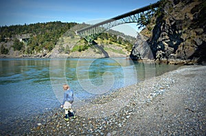 Little girl standing on shingle beach