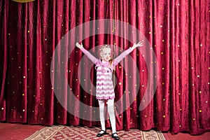 Little girl standing on stage during a performance