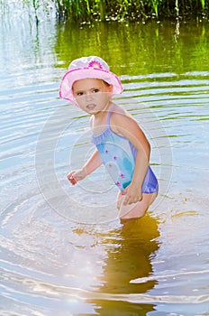 Little girl standing in the water.