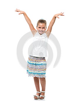 little girl standing on white backdrop raised her hands up