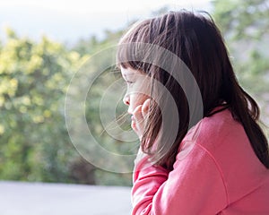 Little girl staring into nature